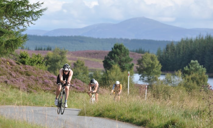 Cyclists climbing steep slopes in Scotland.