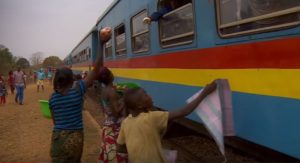 People selling goods to passengers.